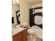 This bathroom boasts a white sink and a patterned black and white shower curtain at 4665 Sw 40Th Pl, Ocala, FL 34474