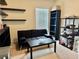 This is a bonus bedroom with floating shelves and a black futon at 4665 Sw 40Th Pl, Ocala, FL 34474