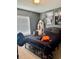 This cozy bedroom has a black metal bedframe and carpet flooring at 4665 Sw 40Th Pl, Ocala, FL 34474