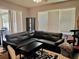 Comfortable living room featuring a large sectional sofa, sliding glass doors, and lots of natural light at 4665 Sw 40Th Pl, Ocala, FL 34474