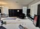 Spacious living room featuring black bookshelves, comfortable seating, and natural light from the large window at 4665 Sw 40Th Pl, Ocala, FL 34474