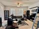 Bright living room featuring a large sectional sofa, lots of natural light, and a ceiling fan at 4665 Sw 40Th Pl, Ocala, FL 34474