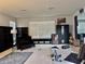 Open living room with a tufted loveseat, built-in shelving, and plenty of space for exercise equipment at 4665 Sw 40Th Pl, Ocala, FL 34474