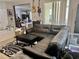Cozy living room featuring a large sectional sofa, lots of natural light, and an open floorplan at 4665 Sw 40Th Pl, Ocala, FL 34474