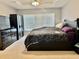 Main bedroom featuring tray ceiling, ceiling fan and neutral color scheme at 4665 Sw 40Th Pl, Ocala, FL 34474