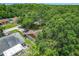 An aerial view of the home and surrounding property shows dense foliage and landscaping at 4720 Wildflower Dr Dr, Lakeland, FL 33811