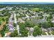 Aerial view of the home and surrounding neighborhood with lake and fountain at 4720 Wildflower Dr Dr, Lakeland, FL 33811
