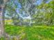 Large backyard area with partial lake views and lush tree coverage at 4720 Wildflower Dr Dr, Lakeland, FL 33811