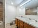 Bathroom featuring double sinks, tiled shower, and tiled floors at 4720 Wildflower Dr Dr, Lakeland, FL 33811