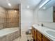 Bathroom featuring double sinks, tiled shower, and tiled floors at 4720 Wildflower Dr Dr, Lakeland, FL 33811