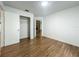 A bedroom with light walls, wood flooring, and an open closet at 4720 Wildflower Dr Dr, Lakeland, FL 33811