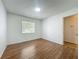 Bedroom features wood floor and natural light from window at 4720 Wildflower Dr Dr, Lakeland, FL 33811