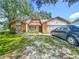 Quaint home showcasing the yard, siding, shutters, and garage at 4720 Wildflower Dr Dr, Lakeland, FL 33811