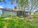 View of the home's rear exterior, including the screened-in sunroom at 4720 Wildflower Dr Dr, Lakeland, FL 33811