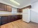 Kitchen with wood cabinets, sink, and white refrigerator at 4720 Wildflower Dr Dr, Lakeland, FL 33811