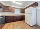 The kitchen features brown cabinets and wood flooring at 4720 Wildflower Dr Dr, Lakeland, FL 33811