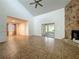Open living space with vaulted ceilings, a stone fireplace, and sliding glass door access at 4720 Wildflower Dr Dr, Lakeland, FL 33811