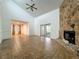 Bright living room with vaulted ceilings, large stone fireplace, and sliding glass doors at 4720 Wildflower Dr Dr, Lakeland, FL 33811
