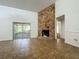 Spacious living room featuring tile floors and a striking stone fireplace at 4720 Wildflower Dr Dr, Lakeland, FL 33811
