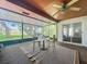 Enclosed sunroom with ceiling fan and sliding glass door access to the home's interior at 4720 Wildflower Dr Dr, Lakeland, FL 33811