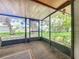 View from sunroom shows the serene backyard and nearby lake at 4720 Wildflower Dr Dr, Lakeland, FL 33811