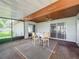 The enclosed sunroom has a table and chairs, plus multiple doors leading inside at 4720 Wildflower Dr Dr, Lakeland, FL 33811