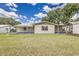 Spacious backyard featuring a covered patio and lush green lawn, perfect for outdoor activities at 508 Boger N Blvd, Lakeland, FL 33803