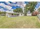Expansive backyard showing a well-maintained lawn, storage shed, and perimeter fence, offering privacy at 508 Boger N Blvd, Lakeland, FL 33803