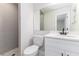 Neutral bathroom with gray tiled shower, white vanity, and modern fixtures at 508 Boger N Blvd, Lakeland, FL 33803