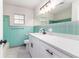 Bright bathroom features turquoise tile, hexagon tile floor, and modern white vanity at 508 Boger N Blvd, Lakeland, FL 33803
