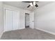 Bedroom with carpet, ceiling fan, white trim, and double door closet at 508 Boger N Blvd, Lakeland, FL 33803