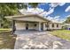 Home exterior featuring a covered carport and an inviting turquoise front door, adding curb appeal at 508 Boger N Blvd, Lakeland, FL 33803