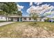 Charming single-story home with white exterior, carport, landscaped yard and inviting blue front door at 508 Boger N Blvd, Lakeland, FL 33803