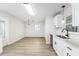 Eat-in kitchen featuring stainless steel appliances, modern white cabinets, and hardwood floors at 508 Boger N Blvd, Lakeland, FL 33803