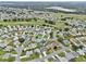 Aerial view of a home in a neighborhood next to a golf course at 5771 Macaw Pl, Lakeland, FL 33809