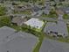 An aerial view of the house and surrounding homes showcasing backyard and nearby streets at 5771 Macaw Pl, Lakeland, FL 33809