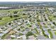 Aerial view of the property in a neighborhood surrounded by lush greenery at 5771 Macaw Pl, Lakeland, FL 33809