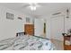 Charming bedroom with floral bedding, hardwood dresser, ceiling fan, and a wardrobe at 5771 Macaw Pl, Lakeland, FL 33809