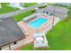 Aerial view of the sparkling community pool with ample lounge chairs and well-maintained surroundings at 5771 Macaw Pl, Lakeland, FL 33809