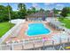 Beautiful community pool featuring ample seating, a hot tub, and a well-maintained pool area at 5771 Macaw Pl, Lakeland, FL 33809