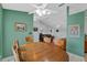 Cozy dining area with wood table, chairs, ceiling fan, and mirrored wall at 5771 Macaw Pl, Lakeland, FL 33809