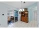 Dining room with sliding doors to Florida room, tile floor and wood china cabinet at 5771 Macaw Pl, Lakeland, FL 33809