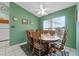 Dining area featuring a wooden table set, a ceiling fan, and a bright window at 5771 Macaw Pl, Lakeland, FL 33809