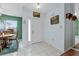 Bright entryway with white tile flooring, a sidelight window, and neutral-toned walls at 5771 Macaw Pl, Lakeland, FL 33809