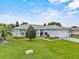 Well-maintained home featuring green lawn and lovely landscaping at 5771 Macaw Pl, Lakeland, FL 33809