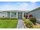 Inviting front porch with decorative columns, tiled walkway, and neatly trimmed landscaping at 5771 Macaw Pl, Lakeland, FL 33809