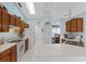 Well-lit kitchen with white countertops, wood cabinets, and seamless access to the adjacent dining area at 5771 Macaw Pl, Lakeland, FL 33809