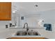 Bright kitchen featuring a double sink, white countertops, and a view into the living area at 5771 Macaw Pl, Lakeland, FL 33809