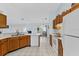 Open kitchen with ample countertop space, wooden cabinetry, and easy access to the living area at 5771 Macaw Pl, Lakeland, FL 33809