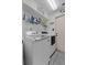 Convenient laundry room featuring modern washer and dryer units and shelving at 5771 Macaw Pl, Lakeland, FL 33809